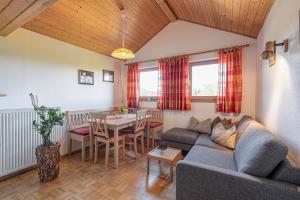 a living room with a couch and a table at Ferienhof Weishäupl in Untergriesbach