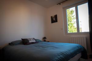 a bedroom with a bed and a window at Bonuit in Le Mans