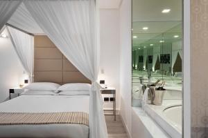 a bedroom with a bed and a bath tub at LHP Napoli Palace & SPA in Naples