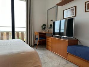 A television and/or entertainment centre at Lets Holidays Apartment Sea Views in Barcelona