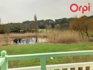 a view of a park with a pond and a fence at Résidence LE BOCAGE PORT BOURGENAY 85440 in Talmont