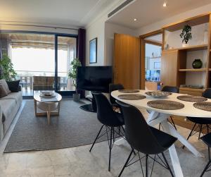 a living room with a table and chairs at Lets Holidays Apartment Sea Views in Barcelona in Barcelona