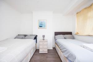 מיטה או מיטות בחדר ב-HeadsonBed- Croydon 4Bedrooms with Parking for the Larger groups