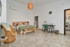 a bedroom with a bed and a table and chairs at El Cine in Canillas de Albaida +26 photos