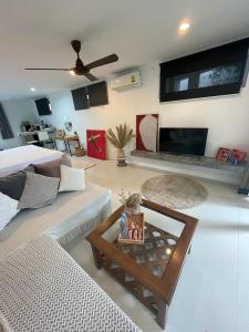 a living room with a couch and a table at Chaweng Beautiful Studio. in Koh Samui