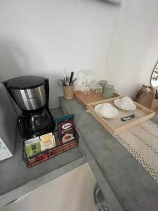 a counter with a coffee maker and a table with a mixer at Chaweng Beautiful Studio. in Koh Samui