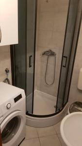 a bathroom with a shower and a washing machine at Stone House Center in Primošten +7 photos