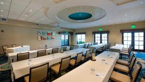 a conference room with long tables and chairs at Hyatt House Naples 5th Avenue in Naples