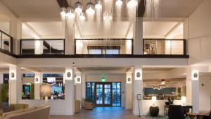 a lobby of a hotel with a chandelier at Hyatt House Naples 5th Avenue in Naples