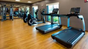 a gym with a row of treadmills and ellipticals at Hyatt House Naples 5th Avenue in Naples