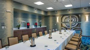 a conference room with a long table and chairs at Hyatt House Naples 5th Avenue in Naples