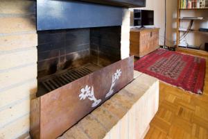 a fire place in a living room with a wood mantle at Appartement à 200m de la télé-cabine de Vercorin in Vercorin