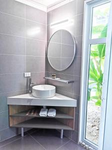 a bathroom with a sink and a mirror at Blue Joys MSR in Siquijor