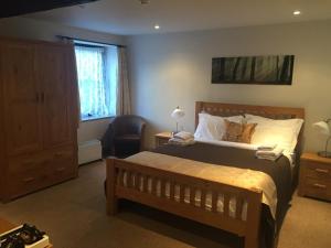 a bedroom with a large bed and a window at The Selsey Arms in West Dean