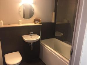 a bathroom with a sink and a toilet and a bath tub at The Selsey Arms in West Dean +86 photos