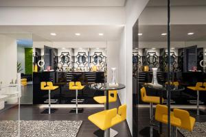 a store with yellow chairs and tables in a room at LHP Napoli Palace & SPA in Naples