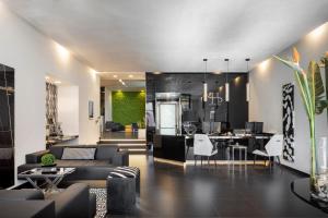 a living room with couches and a dining room at LHP Napoli Palace & SPA in Naples
