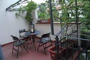 a patio with a table and chairs on a balcony at Burchiello b&b in Florence