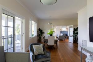 a living room with a table and chairs at Woodland Bay Retreat-Luxury Hamptons Retreat in Lymington