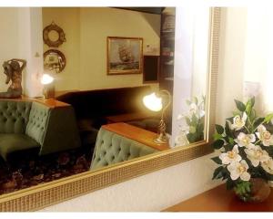 a living room with a couch and a mirror at St Elmo Hotel in Blackpool