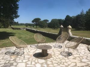 a group of chairs and a table on a patio at La Chartreuse et son Orangerie in Bergerac +81 photos
