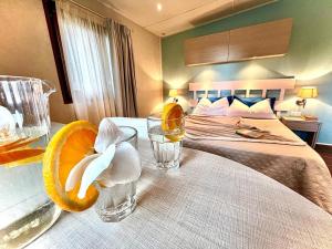 a bedroom with a bed and a table with a glass of water at Camping Village Tuscia Tirrenica in Tarquinia