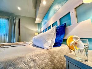 a bedroom with a large bed with blue walls at Camping Village Tuscia Tirrenica in Tarquinia