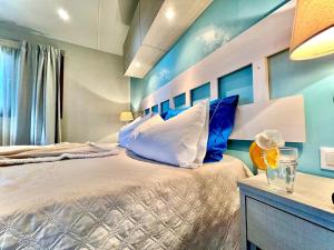 a bedroom with a large bed with blue walls at Camping Village Tuscia Tirrenica in Tarquinia