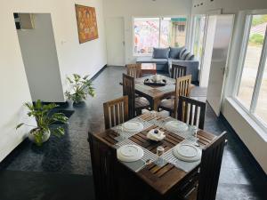 a dining table and chairs in a living room at The Lake Round Guest House in Kandy