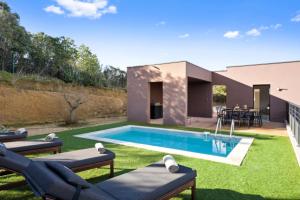 a backyard with a swimming pool and a house at DOMAINE OLMETA in Porticcio