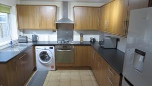 a kitchen with a washing machine and a washer at Templecombe in Temple Combe