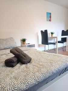 a bedroom with a bed with two chairs and a table at Quiet Location-Workplace-Coffee-Parking-Washer in Schaffhausen