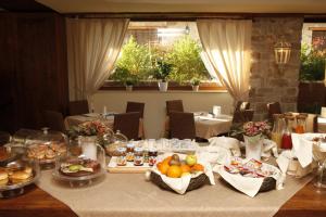 a dining room with a table with food on it at Hotel Villa Clementina in Scafati