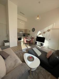 a living room with a couch and a table at Nouvel appart bien-être/confort in Saint-Ouen