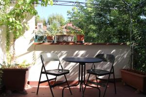 a table and four chairs sitting on a patio at Burchiello b&b in Florence