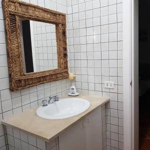 a bathroom with a sink and a mirror at Villa Brancasi con piscina in Brindisi +48 photos