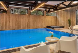 a swimming pool in a house with wooden walls at Casa Brevik in Kristiansand