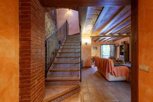 a staircase in a house with a brick wall at Cal Sec in Mas Boquera