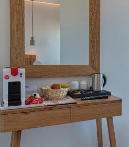 a wooden table with a counter top with a microwave at Harma Boutique Hotel in Hersonissos