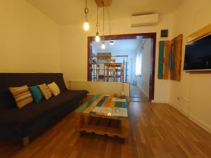 a living room with a couch and a coffee table at B Apartments - Babel Apartment in Timişoara