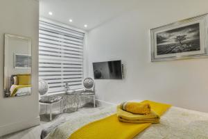 a bedroom with a bed with a yellow blanket on it at The Apartment - Ground Floor - Luxury for up to 4 guests near Open Air Theatre and North Bay in Scarborough