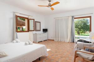 a bedroom with two beds and a ceiling fan at Finca CASA FINA, POOL, BBQ, WIFI in Felanitx