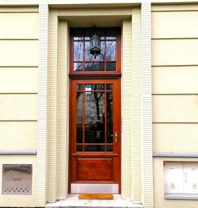 a wooden door on a building with a window at U Siemienia in Krakow