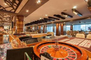 a casino with a roulette wheel on a table at International Hotel Casino & Tower Suites in Golden Sands