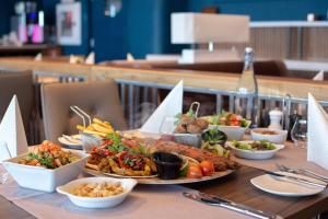 a table with many plates of food on it at International Hotel Casino & Tower Suites in Golden Sands