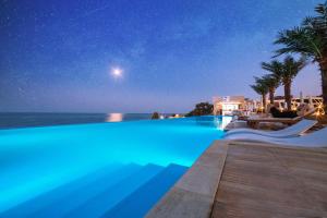 a swimming pool with a view of the ocean at night at International Hotel Casino & Tower Suites in Golden Sands
