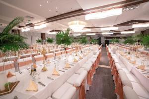 a banquet hall with white tables and white chairs at International Hotel Casino & Tower Suites in Golden Sands