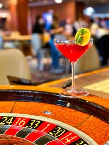 a martini glass sitting on top of a bar at International Hotel Casino & Tower Suites in Golden Sands
