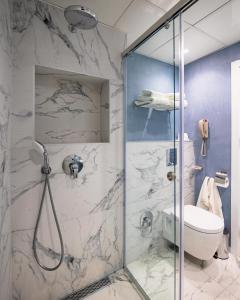 a bathroom with a shower and a toilet at International Hotel Casino & Tower Suites in Golden Sands