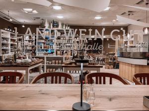 a restaurant with a table and chairs in a room at Land.Wein.Gut Pension in Klingenmünster